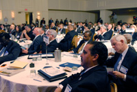 Foreground: Members of Memphis' delegation; Background: members of Salinas' and Chicago's delegations, as well as other attendees listen to opening remarks